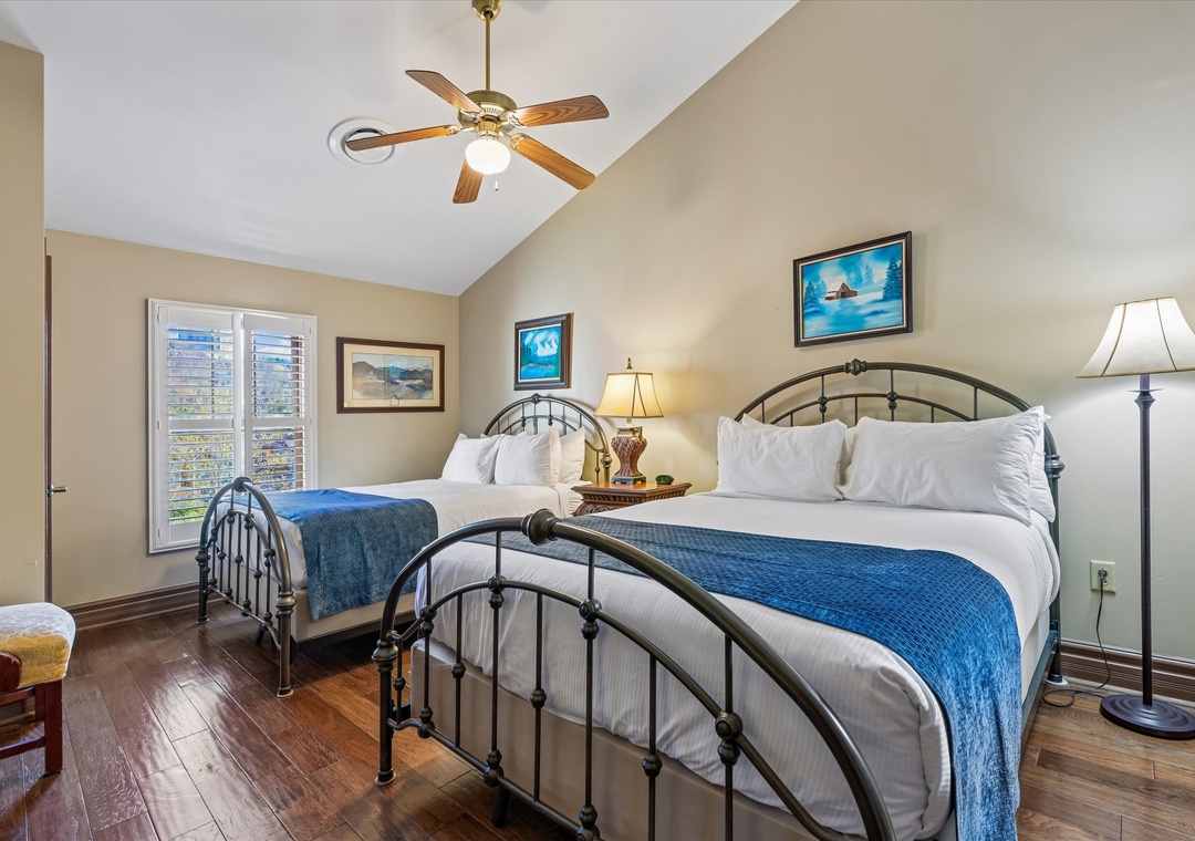Sleep peacefully in your charming twin bedroom with comfortable metal-frame beds, coastal artwork, and a ceiling fan for perfect temperature control.