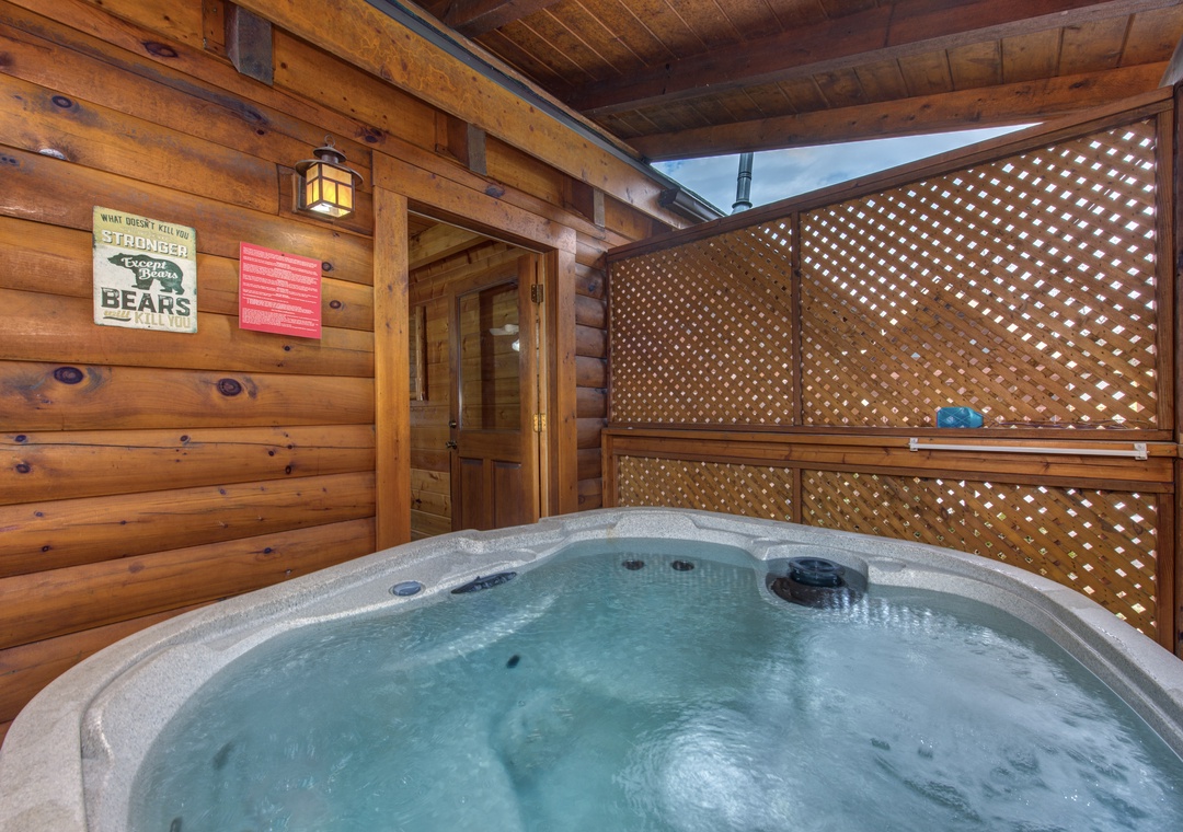 Unwind in your private hot tub surrounded by rustic log walls and charming decor, creating the perfect mountain retreat sanctuary.