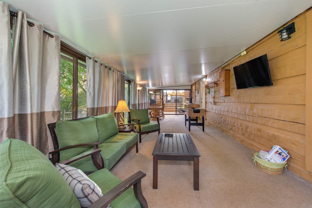 Settle into your private retreat, where green cushioned seating and warm wood accents create a welcoming spot to unwind after a day of adventure.