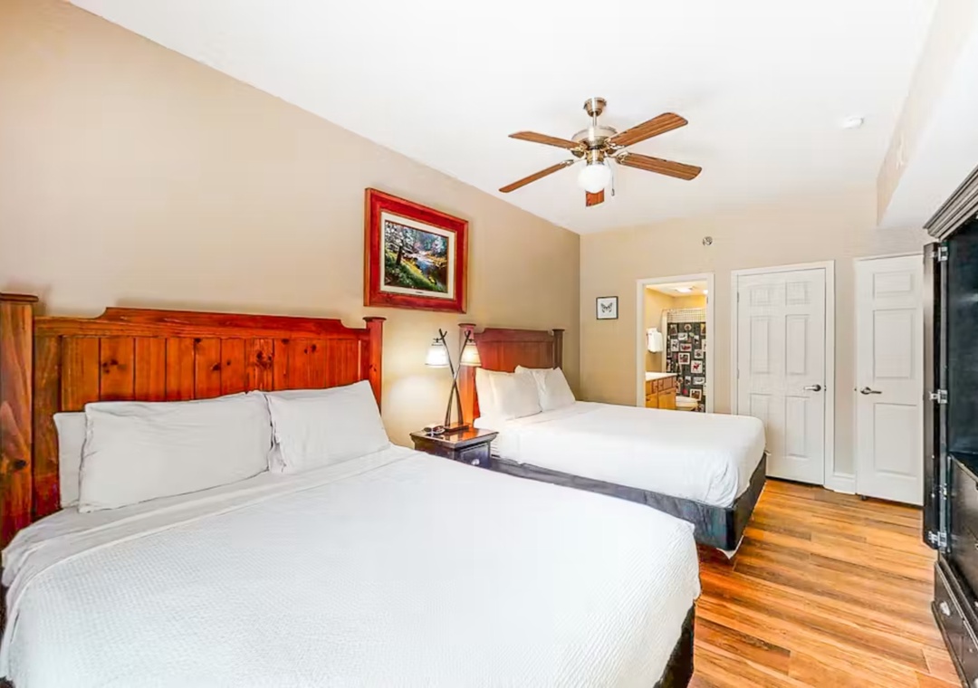 Rest peacefully in your charming room featuring warm wood details, crisp linens, and thoughtful touches like rustic headboards and gentle ceiling fan breezes.