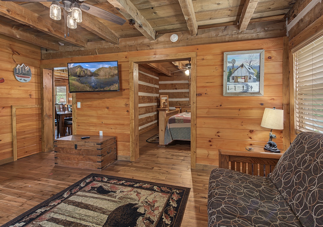 Unwind in your cozy cabin retreat, where rustic wood beams and warm pine walls create a welcoming, home-away-from-home atmosphere for peaceful mountain living.