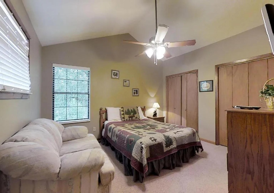 Settle into your private bedroom retreat, where vaulted ceilings, cozy seating, and warm natural light create the perfect space to unwind after exploring the area.