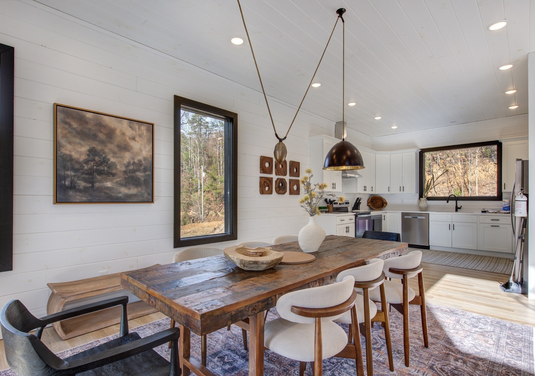 Gather around your rustic dining table where warm wood meets modern elegance, with natural light streaming through windows.