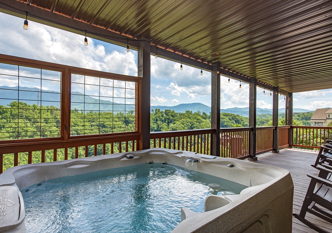 Soak in the hot tub while drinking in panoramic mountain views stretching over lush forested valleys—your private covered deck is the perfect spot to unwind.