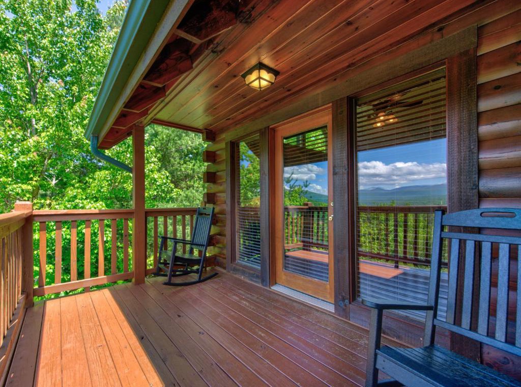 Unwind on your private deck with mountain views, where a cozy rocking chair awaits your morning coffee moments.