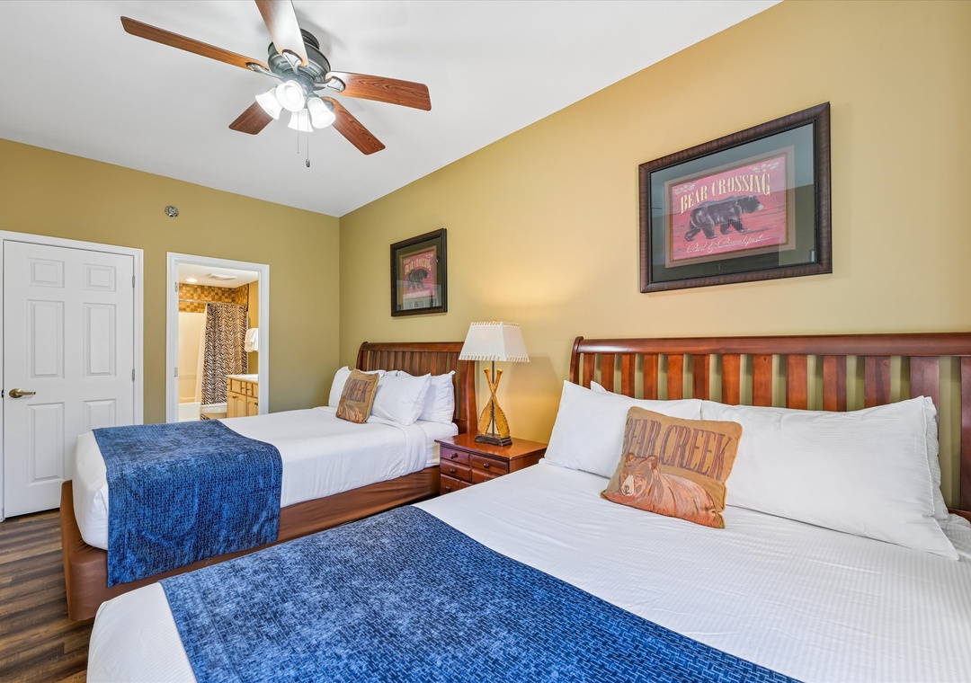 Relax in your cozy bedroom with twin beds dressed in crisp linens and rustic charm, where the gentle ceiling fan keeps you comfortable.