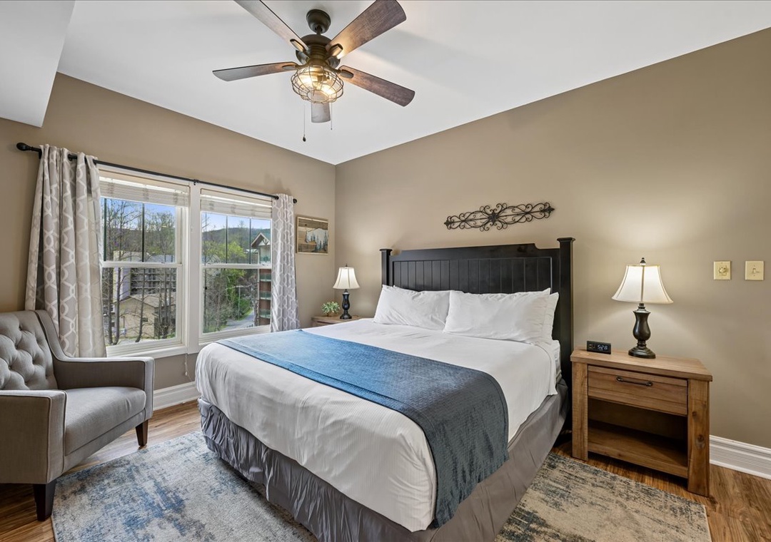 Unwind in your beautifully appointed bedroom, where rustic charm meets modern comfort with a ceiling fan to keep you cool.