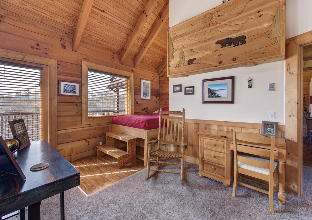 Your rustic wood-paneled bedroom offers cozy mountain charm with nature artwork and peaceful forest views.