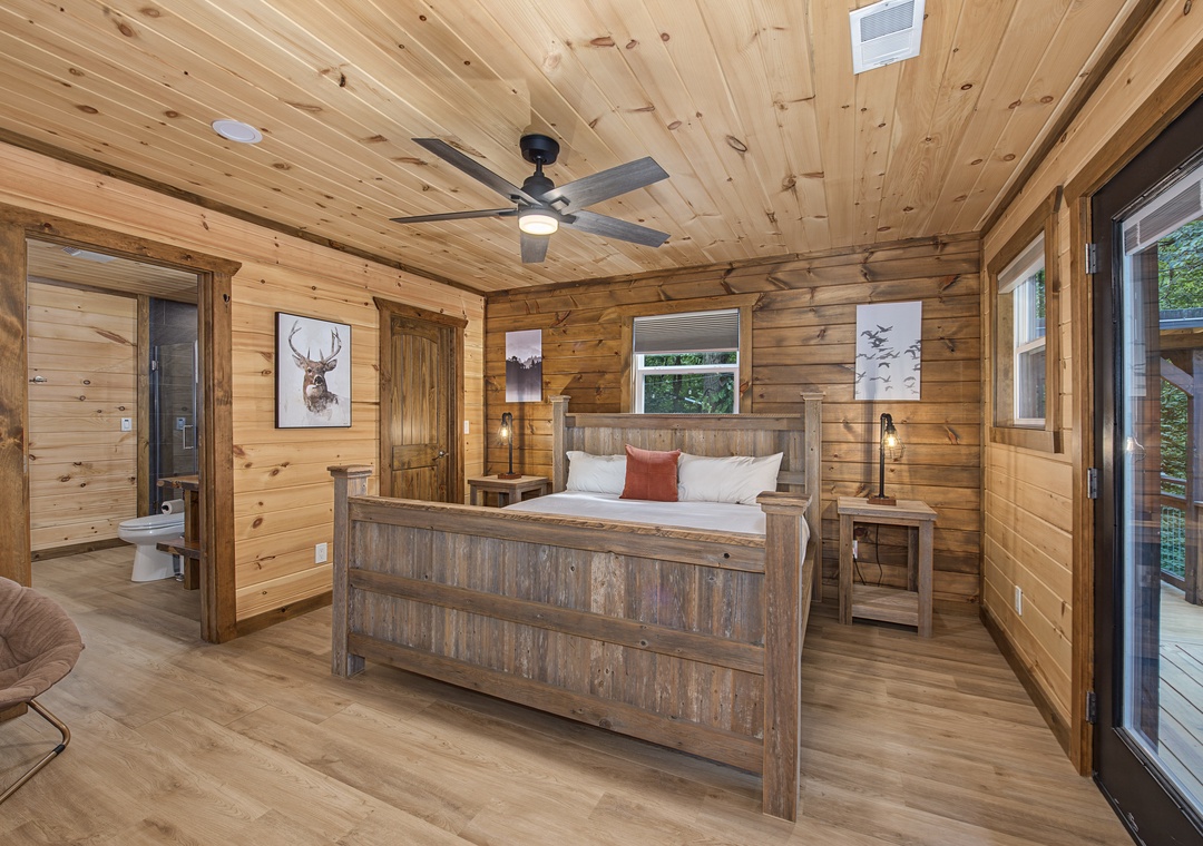 Unwind in your rustic retreat, where natural wood surrounds you and a plush bed invites restful nights beneath the vaulted ceiling. Step onto your private balcony to embrace the mountain air.