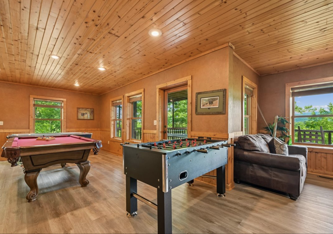 Your game room awaits with a pool table, foosball table, and cozy seating—perfect for friendly competition and relaxation after exploring the mountains.
