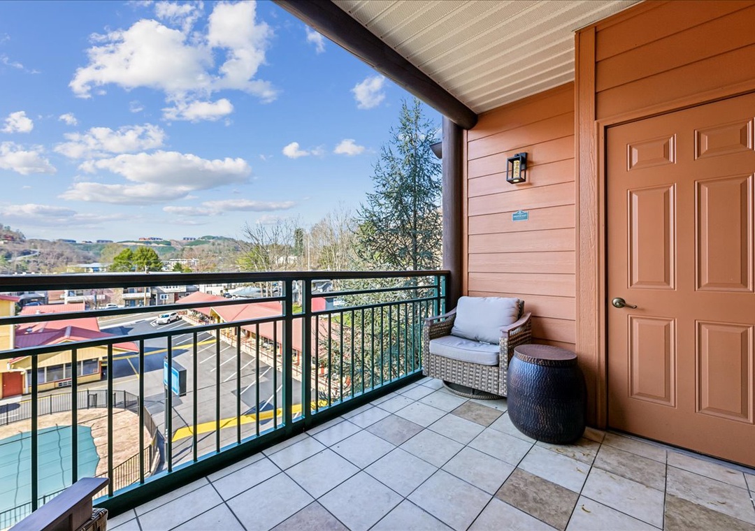 Your private balcony offers sweeping views over the colorful neighborhood rooftops, complete with cozy seating for morning coffee or evening relaxation.