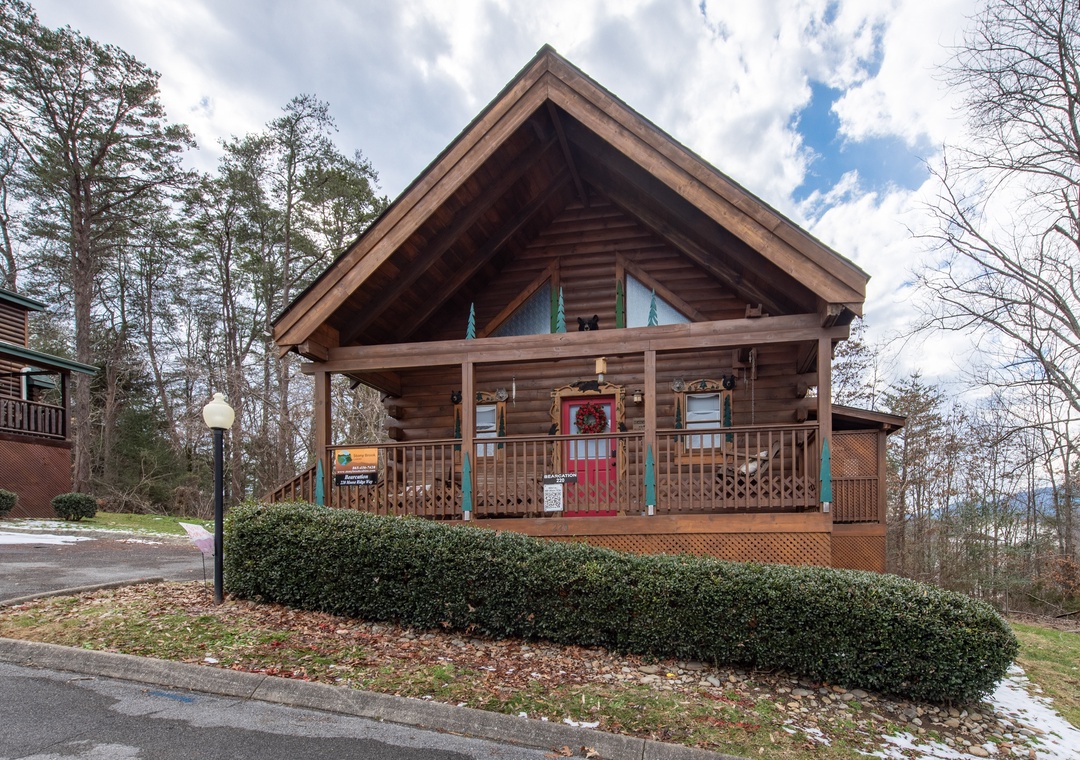 Charming log cabin rental with covered porch and mountain forest setting, perfect for a peaceful getaway retreat.