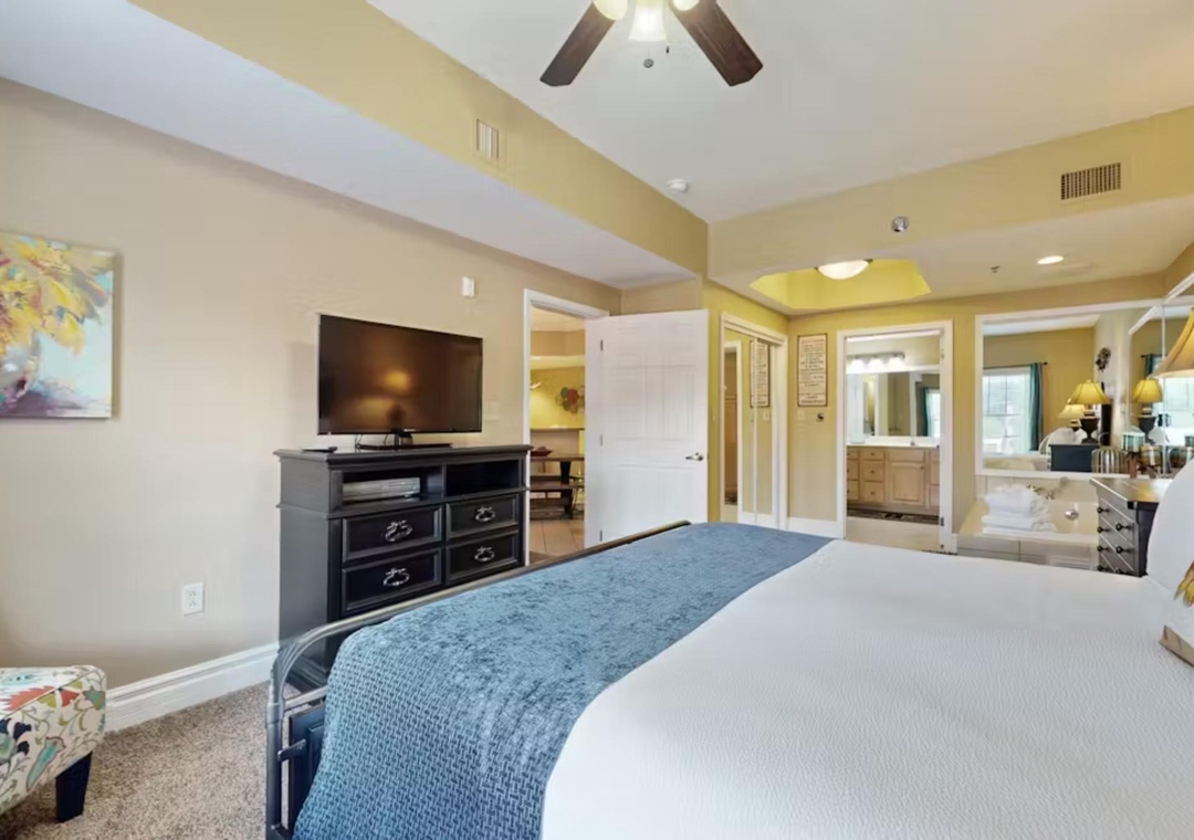 Relax in your spacious suite featuring a plush king bed, modern entertainment center, and elegant ensuite bathroom with luxurious touches.