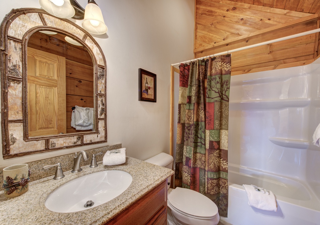 Your private bathroom blends rustic charm with modern comfort, featuring warm wood accents and thoughtful amenities for a cozy mountain retreat.