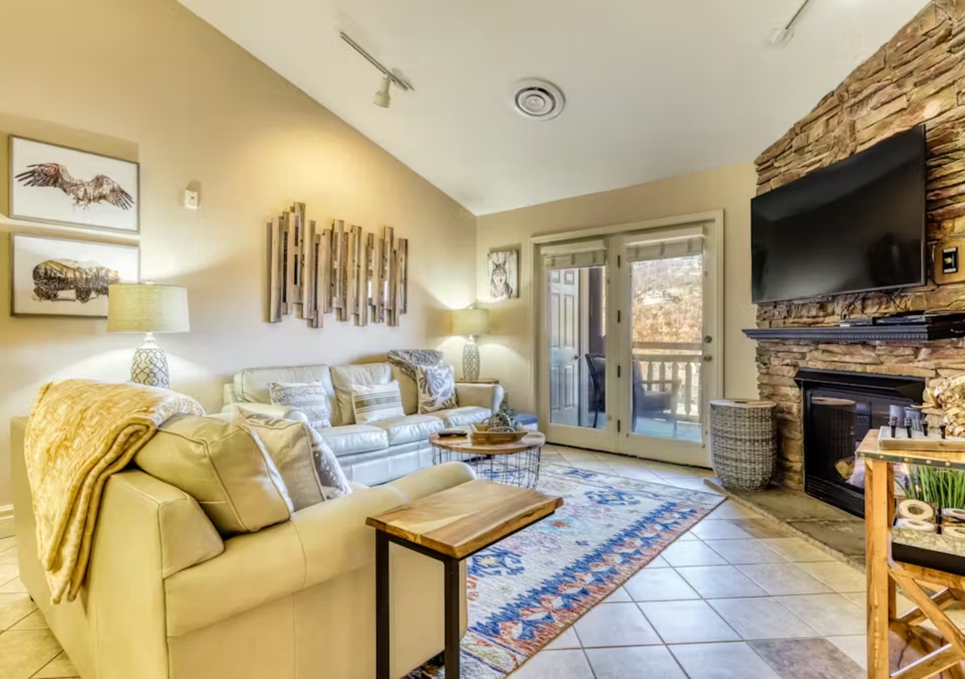 Curl up in your cozy living room with plush leather seating, rustic fireplace, and mountain views from your private balcony.