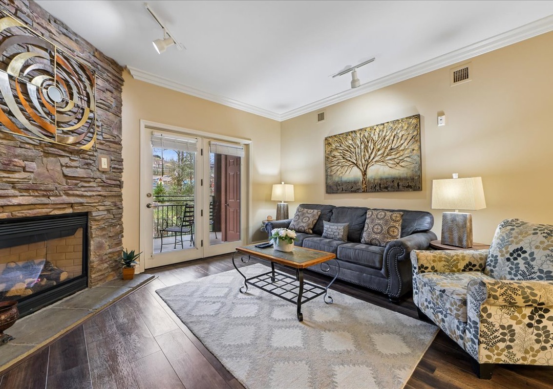Unwind in your elegant living room with cozy fireplace, stylish furnishings, and private balcony access for mountain air.