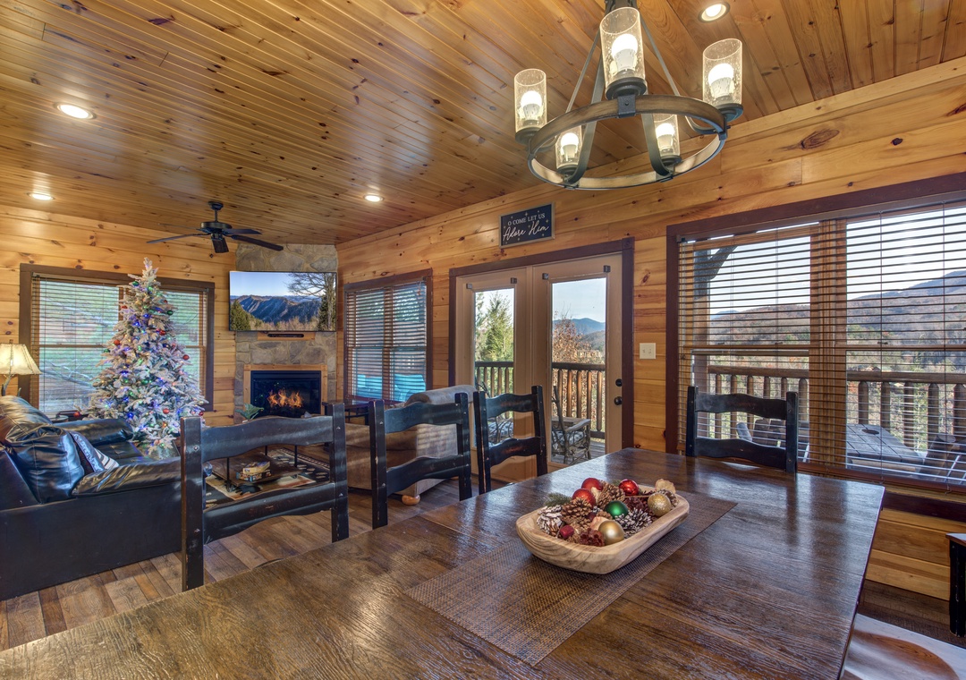 Step into your cozy mountain retreat, where soaring wood-paneled ceilings and a warm fireplace invite you to unwind. Take in stunning mountain vistas through the glass doors opening to your private balcony—your perfect home base for relaxation.