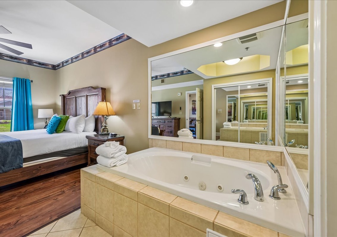 Unwind in your suite featuring a luxurious jetted tub perfect for romantic evenings, with fluffy towels and cozy bedroom just steps away.