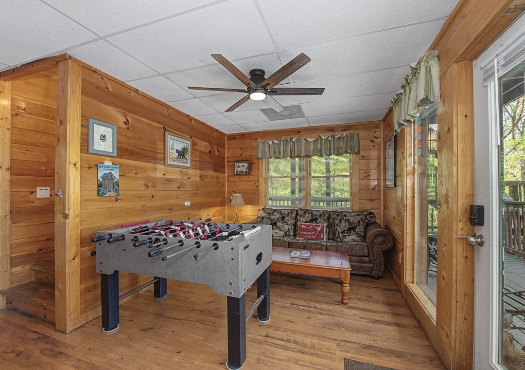 Gather around the foosball table for friendly competitions in your cozy log cabin retreat, complete with rustic charm and forest views.