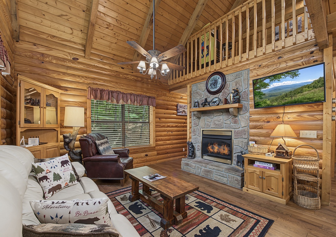 Sink into plush seating by your own stone fireplace, where vaulted wood ceilings and mountain views on the big screen set the scene for your perfect cozy retreat.