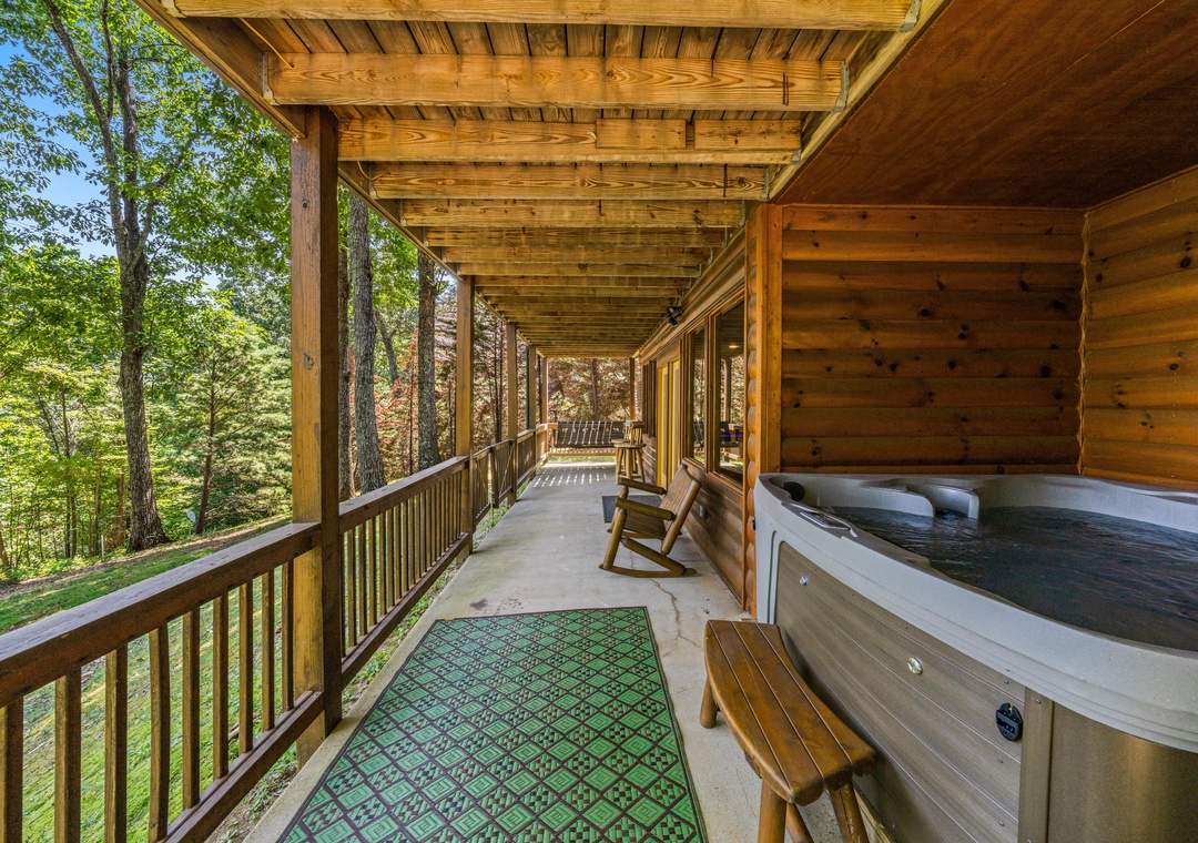 Unwind in the bubbling hot tub on your private covered porch, surrounded by lush forest views and the soothing sounds of nature.