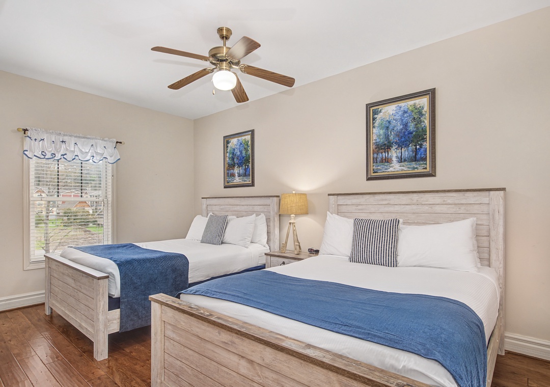 Relax in your serene twin bedroom featuring crisp white linens, rustic wood furniture, and coastal blue accents that create the perfect restful retreat.