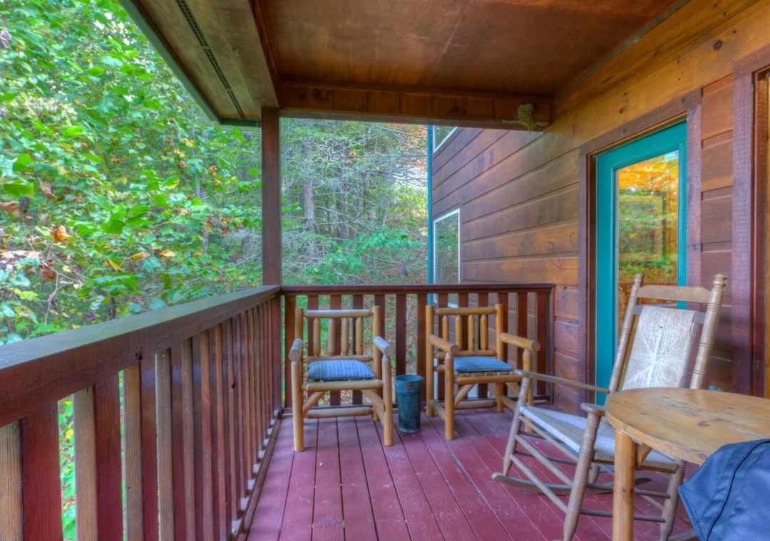 Settle into your private covered deck with rustic rocking chairs, where you can sip morning coffee surrounded by lush forest views and the peaceful sounds of nature.