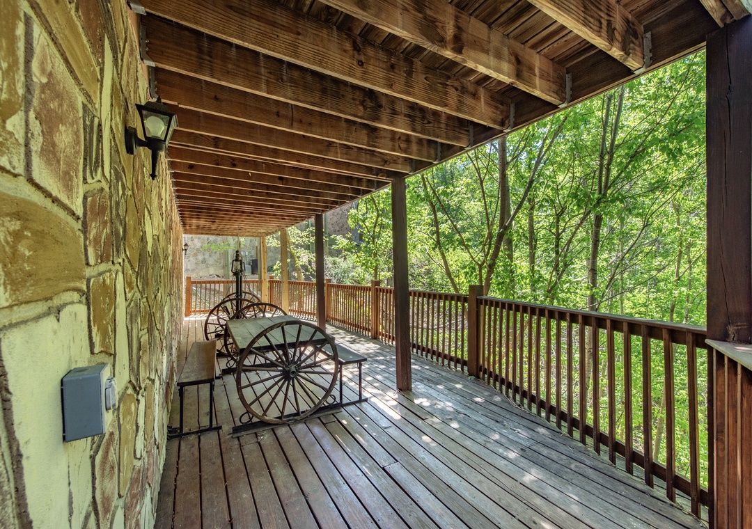 Step onto your private covered deck, where rustic charm meets forest tranquility. Listen to leaves rustling as you unwind in this peaceful woodland retreat.