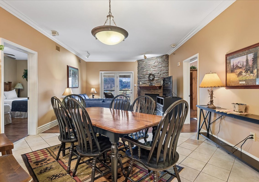 Gather around your spacious dining table for memorable meals, with warm mountain lodge vibes and a cozy stone fireplace creating the perfect atmosphere.