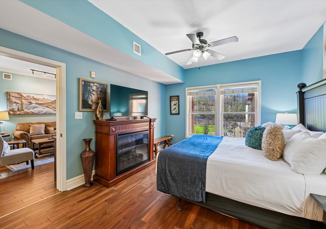 Your peaceful bedroom suite features a cozy fireplace, hardwood floors, and calming blue walls for restful nights.