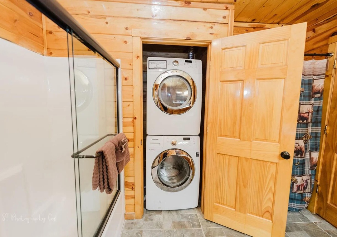 You'll find convenient in-unit laundry tucked neatly into this charming wood-paneled space, complete with stacked washer and dryer for effortless freshening up during your stay.