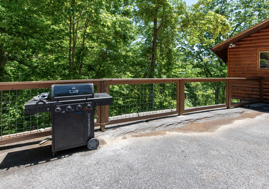 Scenic forest views surround your private outdoor grilling area, where you'll enjoy cooking meals under the canopy of lush trees. Perfect for nature lovers seeking peaceful mountain moments.