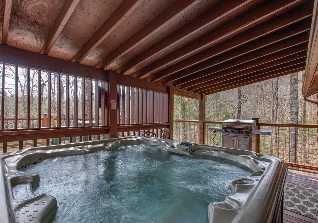 Soak in your private hot tub while surrounded by peaceful forest views and warm wood beams overhead.