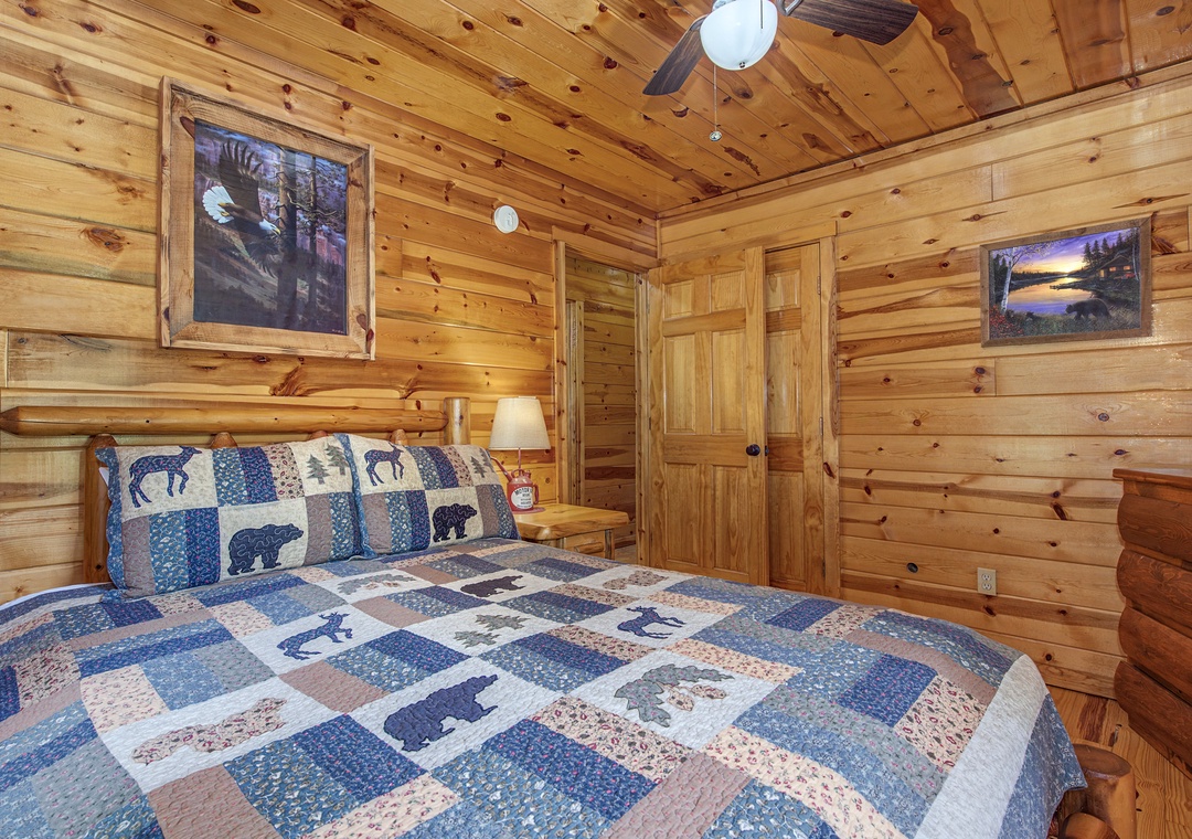 Drift off to sleep surrounded by warm knotty pine and wilderness-inspired artwork. Your cozy cabin bedroom features handcrafted furniture and rustic charm perfect for mountain getaways.