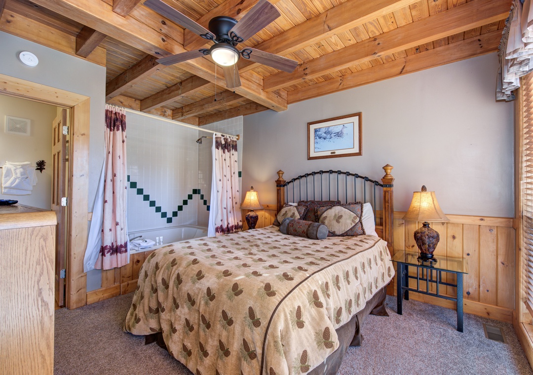 Rustic exposed beams and romantic jacuzzi create your perfect mountain retreat bedroom sanctuary.