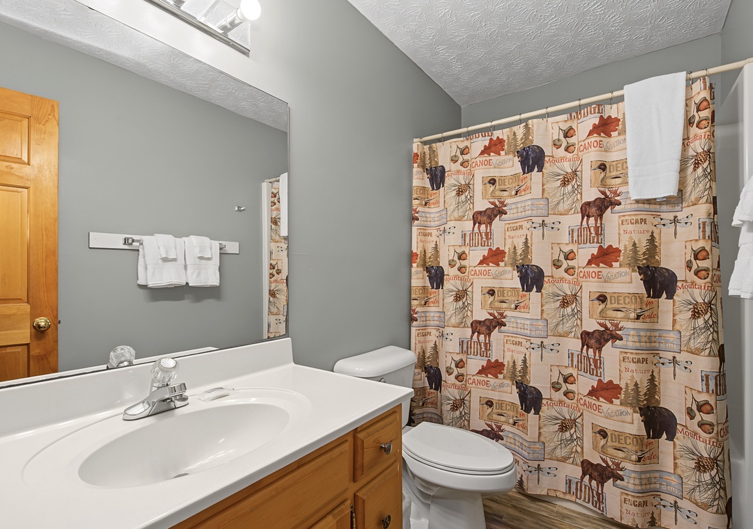 Step into your cozy bathroom where rustic lodge charm meets comfort. Fresh towels await after a relaxing shower, and every detail has been thoughtfully chosen to make you feel right at home.