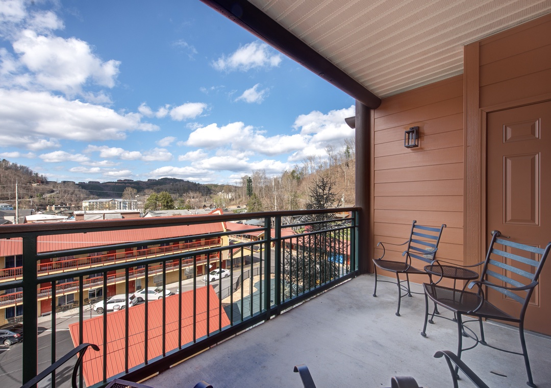 Step onto your private balcony with two comfortable chairs, perfect for morning coffee while enjoying mountain views and fresh air.