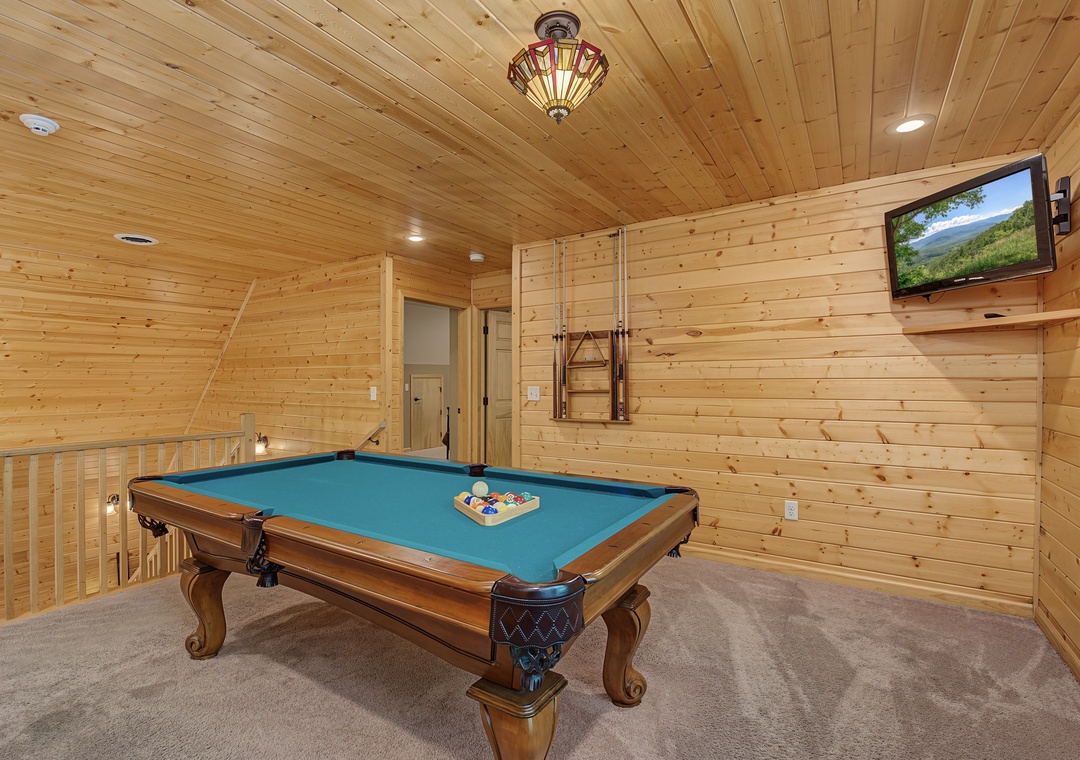 Challenge your friends to a friendly game on your own pool table, surrounded by warm wood and mountain views on the TV.