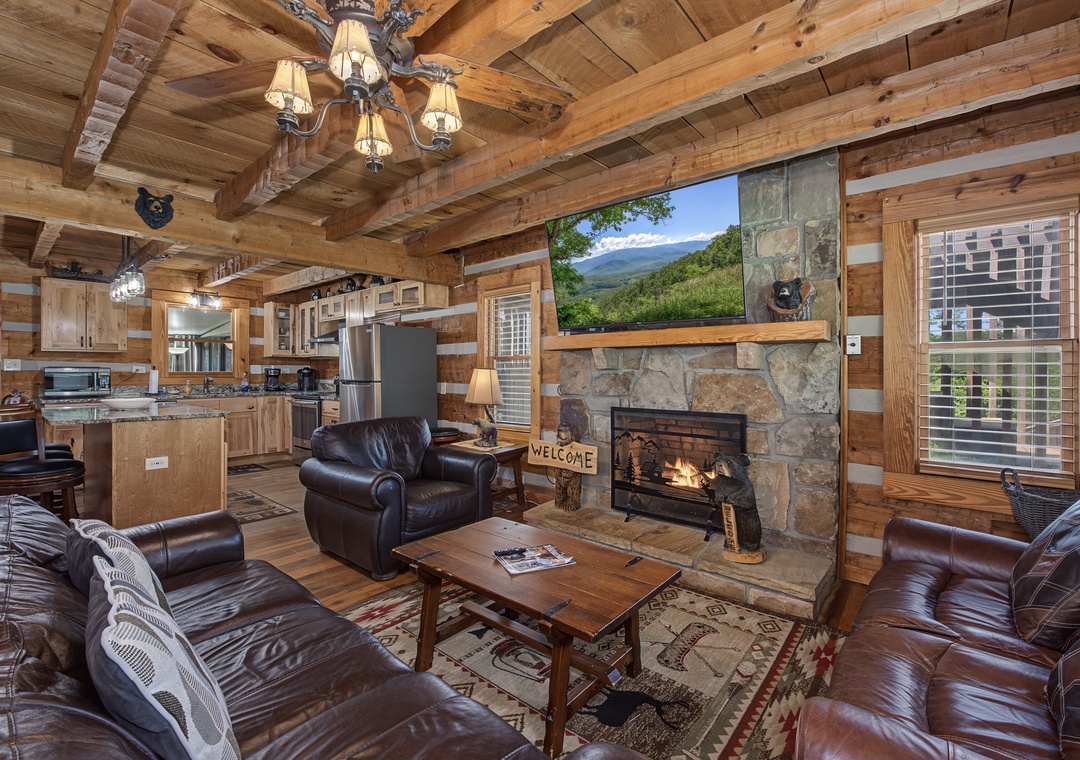 Sink into leather seating, warm up by the stone fireplace, and admire mountain views through the large picture window. The open kitchen invites you to gather and feel right at home in this cozy cabin.