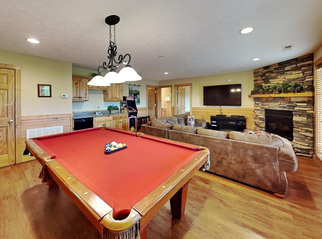 Your perfect game night awaits with pool table, cozy fireplace, and open kitchen for snacks and drinks.