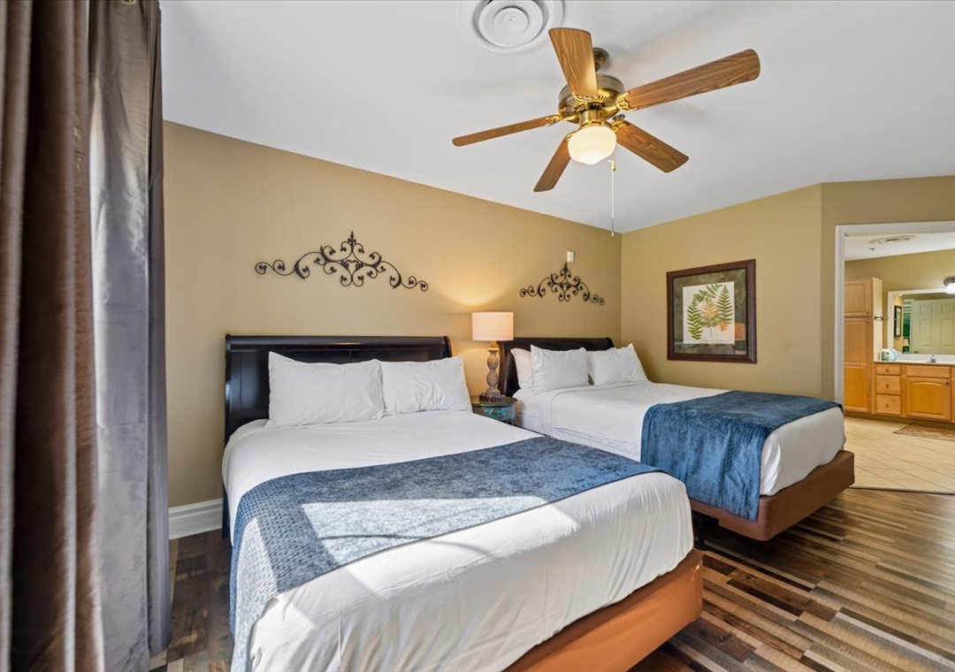 Relax in your spacious room with twin beds, crisp linens, and a ceiling fan for perfect comfort.