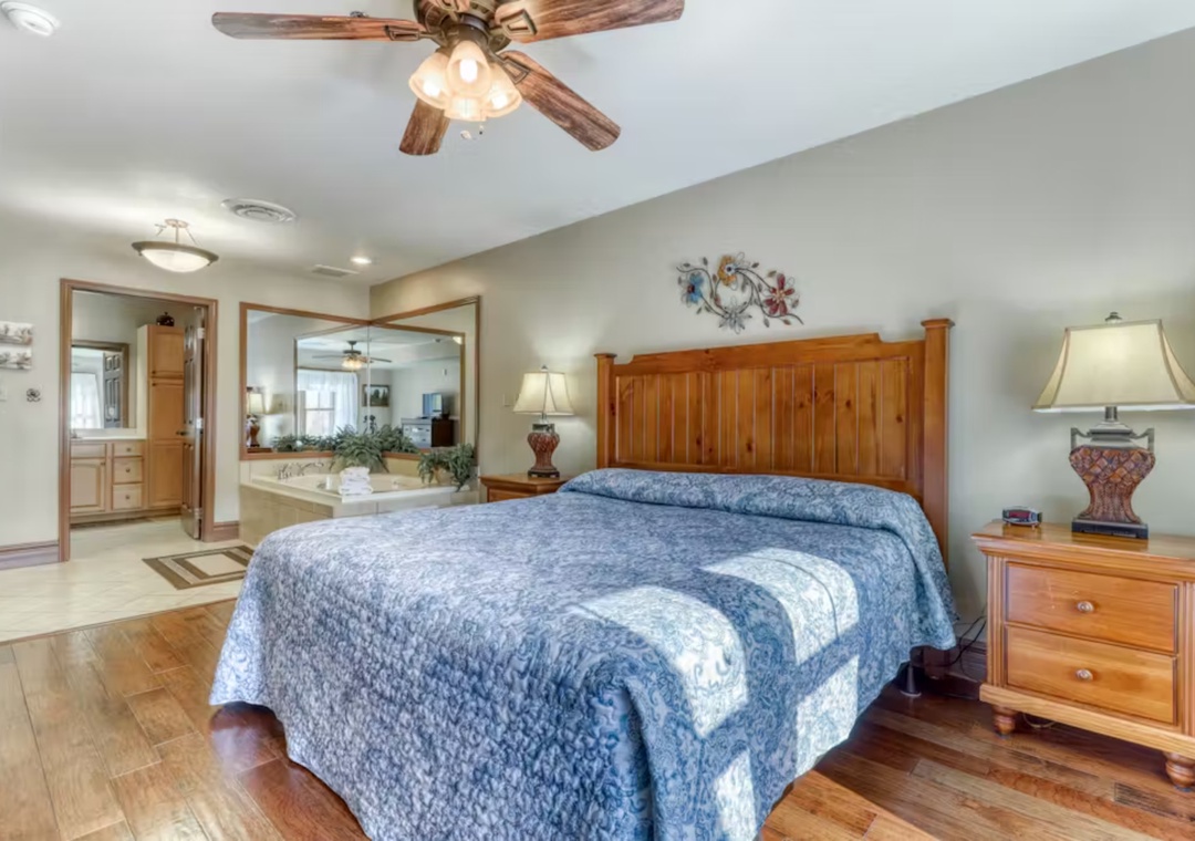 Unwind in your spacious master suite with warm wood accents, ceiling fan comfort, and an en-suite bathroom featuring a relaxing jetted tub.