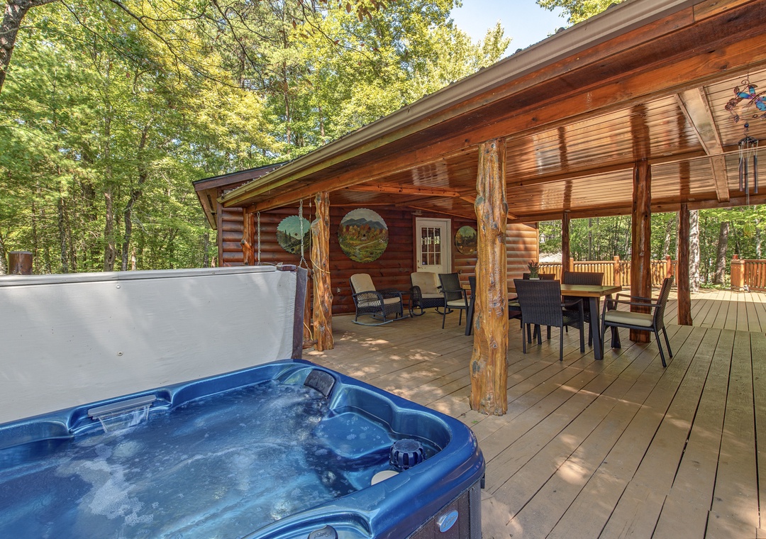 Soak in the bubbling hot tub on the private deck, then gather around the outdoor dining table. Towering trees surround your peaceful retreat.