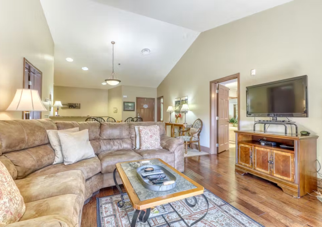 Sink into plush sofas in your spacious living room, where warm lighting and hardwood floors create the perfect retreat.