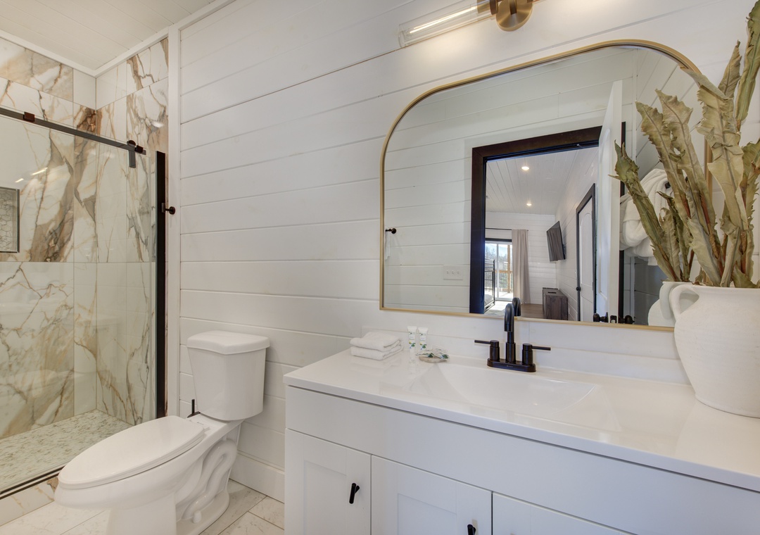 Unwind in your elegant bathroom featuring a marble shower, modern vanity, and thoughtful touches that make your stay feel like home.