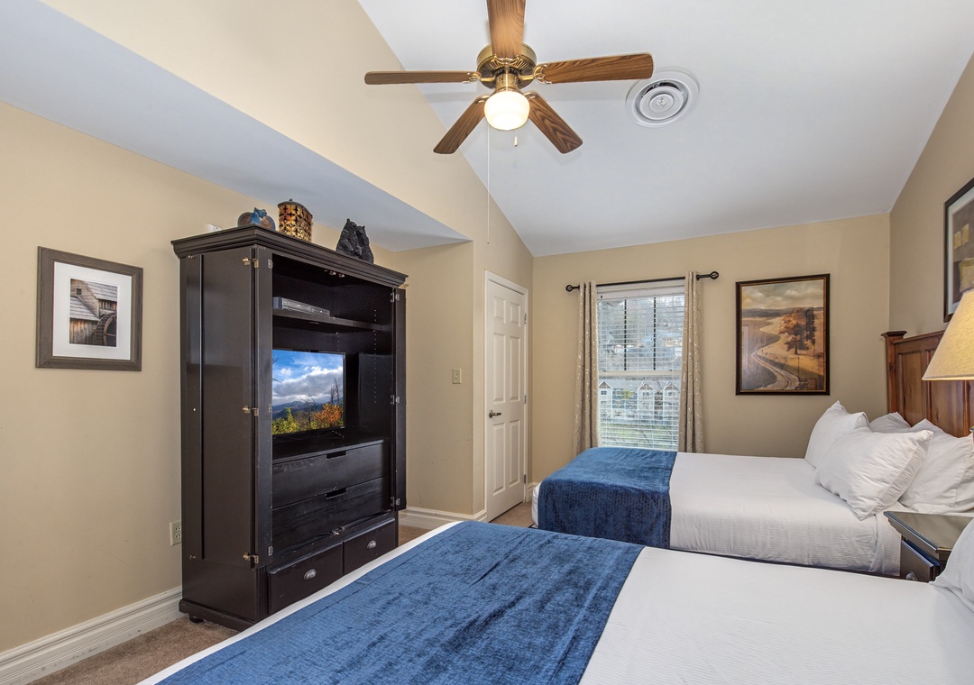 Unwind in your comfortable twin bedroom with flat-screen TV, ceiling fan, and peaceful mountain views from your window.