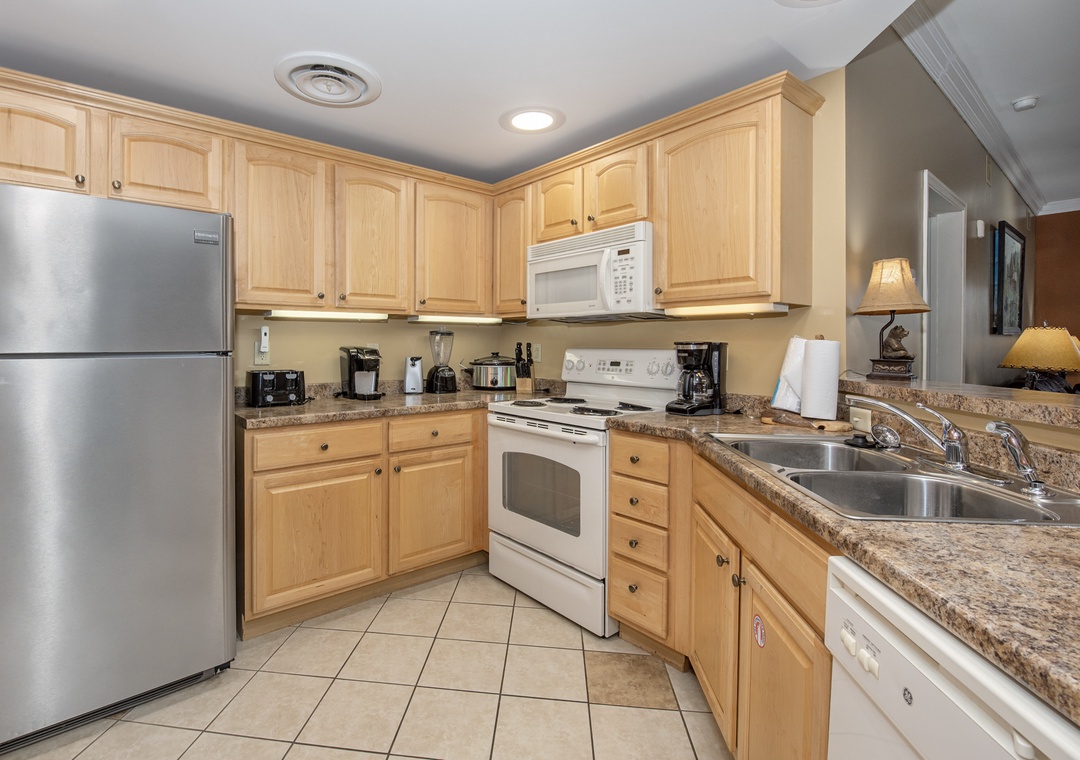 Prepare your favorite meals in this fully equipped kitchen featuring granite countertops, stainless steel appliances, and everything you need for cooking.