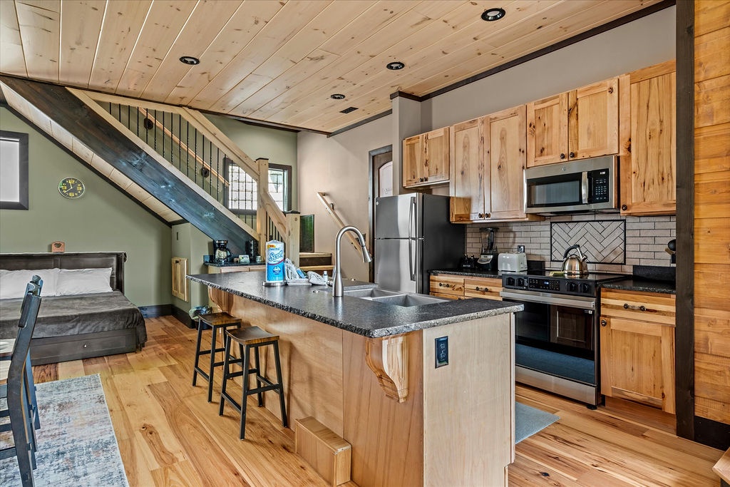 Step into your open-concept mountain retreat with a fully equipped kitchen, cozy loft sleeping area, and warm natural wood finishes throughout. Everything you need is right here, ready for your getaway.