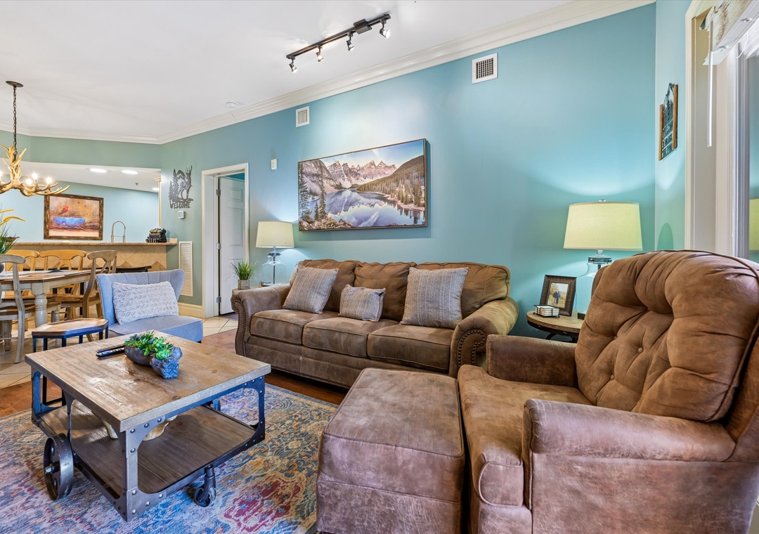 Sink into plush leather seating surrounded by calming turquoise walls, where your mountain getaway begins in this thoughtfully designed living space.