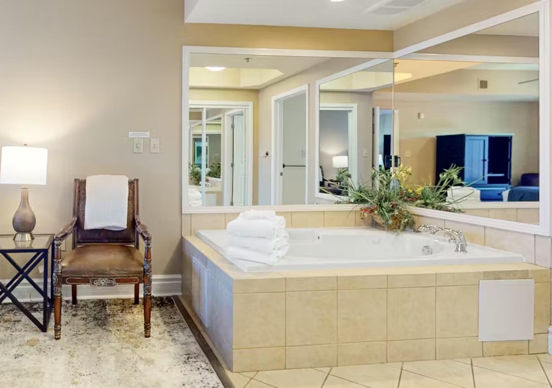 Indulge in your private spa oasis with a luxurious soaking tub surrounded by elegant tile work and soft lighting.